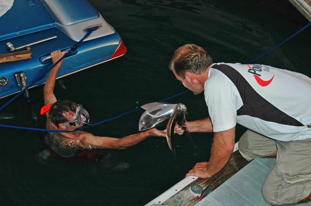 Kevin Cooper (right) hands Terry Sobo a new propeller, just one of those little tasks powerboat crew’s have to do.   - Key West to Cancun world record © Jay Nichols